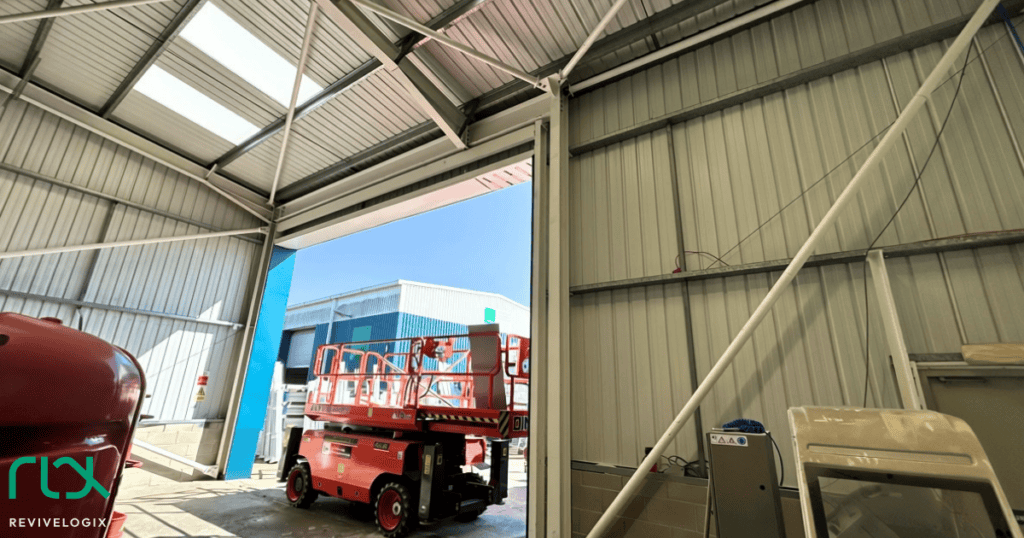 Inside the widened door opening at Rapid PVCU Systems, with the new steel frame and a scissor lift outside